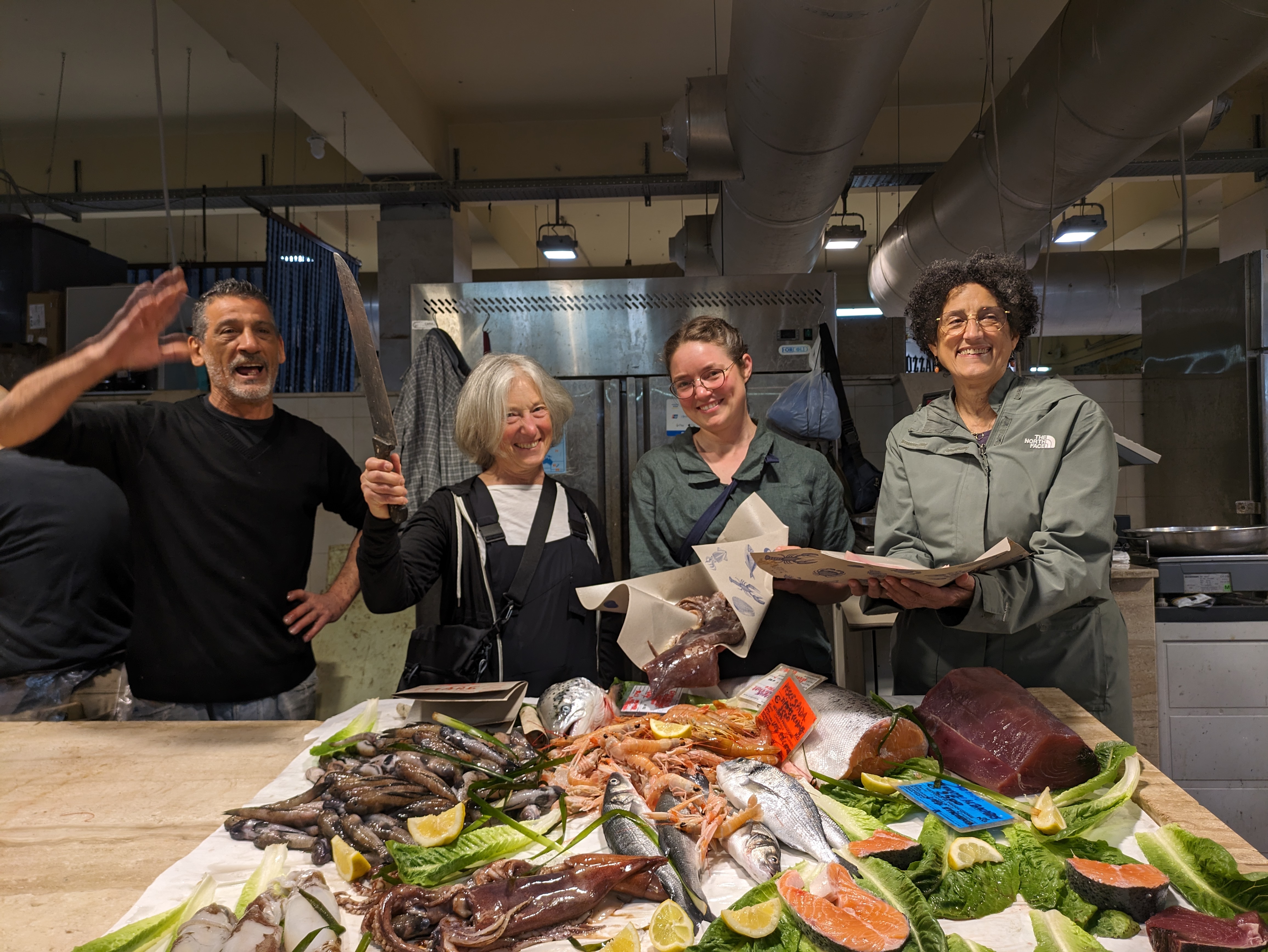 Guests with the fishmonger at Cagliari market